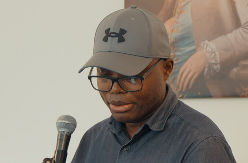 george reading at a poetry event.