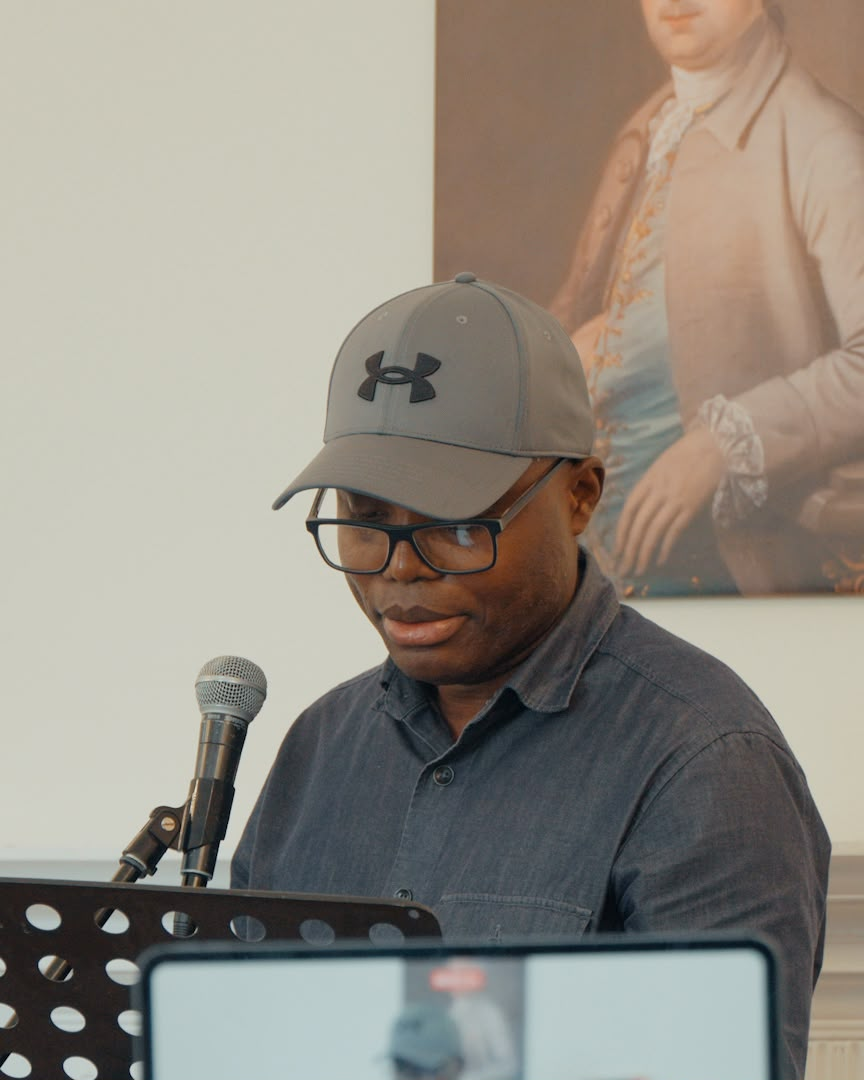 george reading at a poetry event.